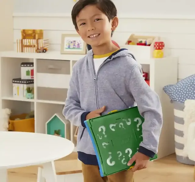 A boy carrying the folded game under his arm