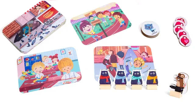 The board sections, cat movers on wooden stands, the Mean Mouse and heart charms laid out on a white background
