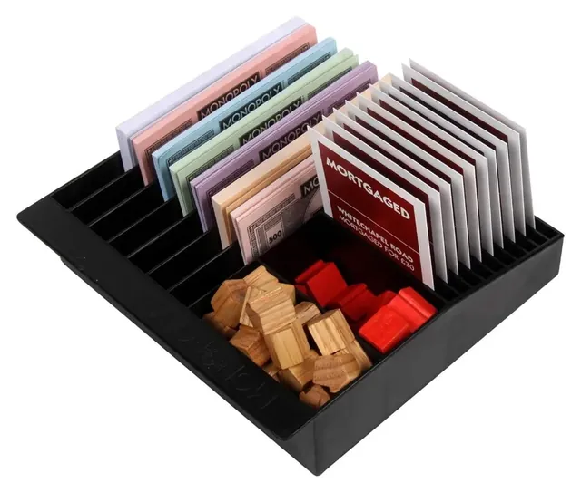 The banker's tray holding title deeds, wooden houses and red wooden hotels