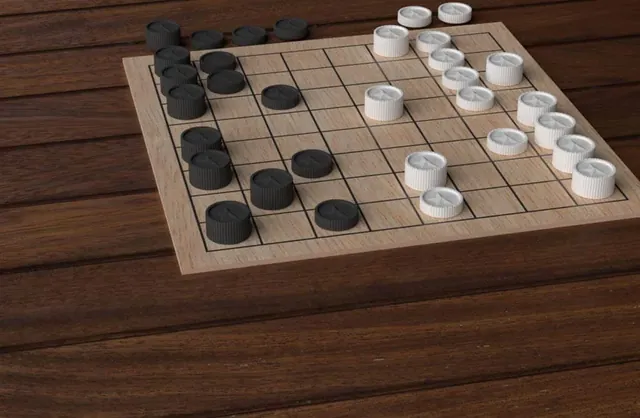 The Backlash board on a wooden table with black and white tokens mid-game