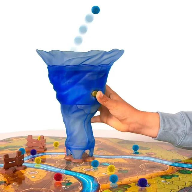 A hand holding the blue tornado as a sheep pom-pom shoots out of the top