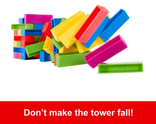 A fallen UNO Stacko tower, with coloured blocks scattered