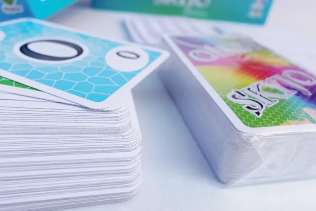 Close-up of a SKYJO deck with a 0 card on top