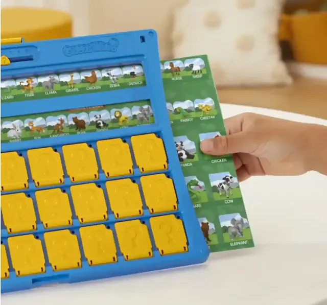 A hand sliding an animal sheet into the blue frame