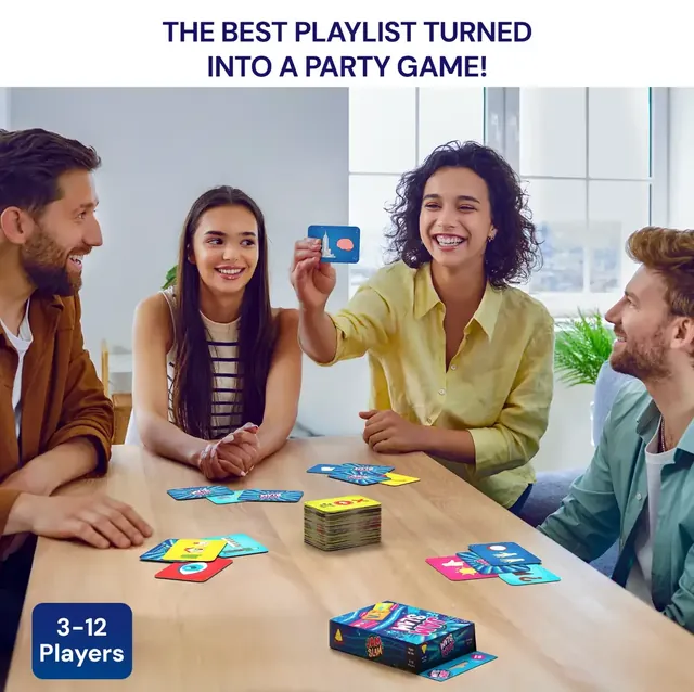 Four adults playing at a table, one holding up a card