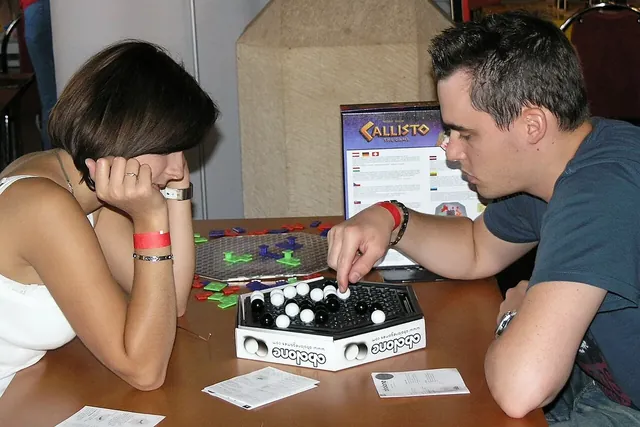 Two people playing Abalone at a table at a games event