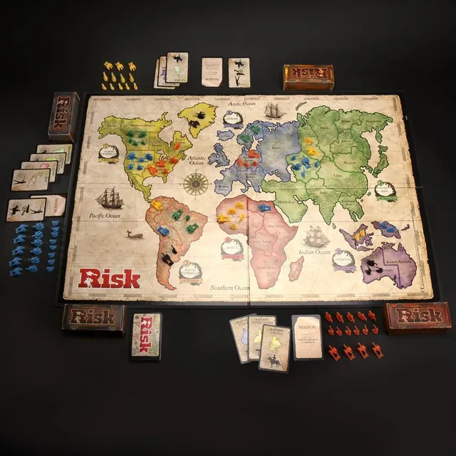 The Risk world-map board laid out with the armies, war crates, cards and dice