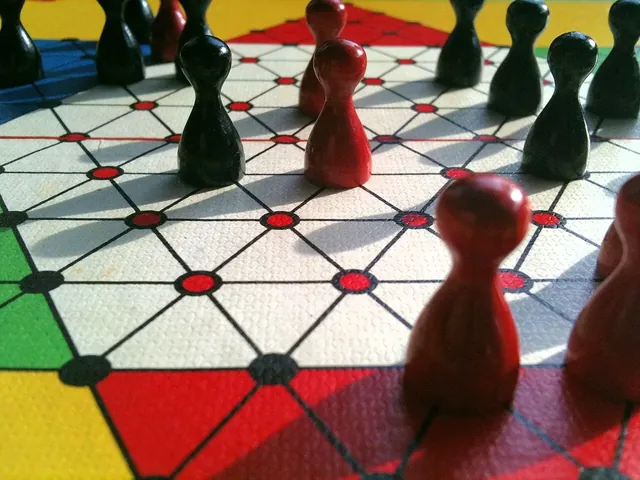 Pawn-shaped pieces on a large star board printed in red, yellow, green and blue