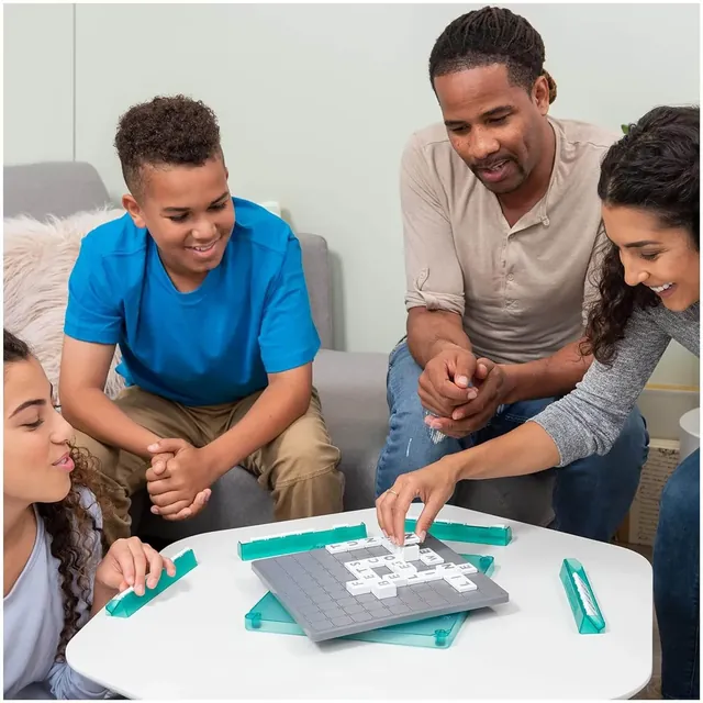 A family of four playing Upwords around a low white table