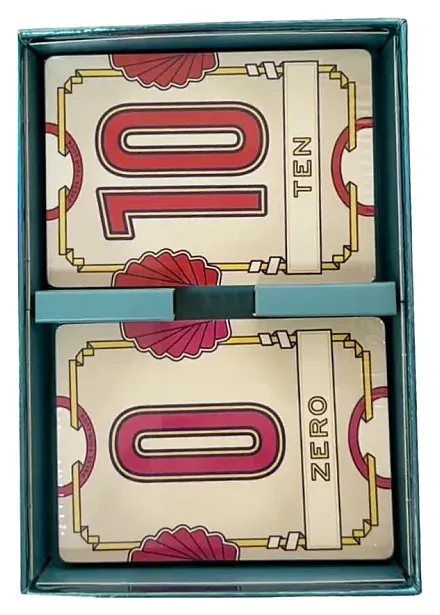 The inside of a Flip 7 box holding a stack of cards, with a red 10 and a 0 on top