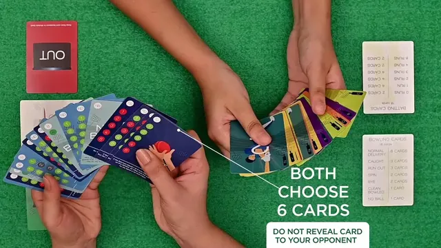 Two players' hands choosing six cards each over a green table, with Out, Not Out and reference cards laid out (still from Binca's video)