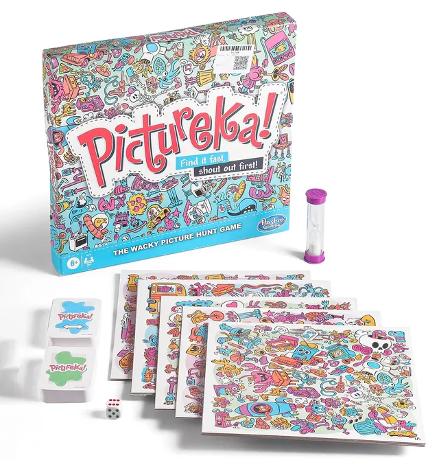 The Pictureka! box with picture tiles fanned out in front, piles of blue and green mission cards and a sand timer
