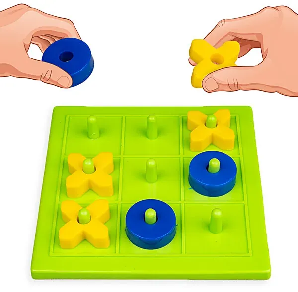 Hands about to place a blue zero and a yellow cross on a green board with a peg in each square