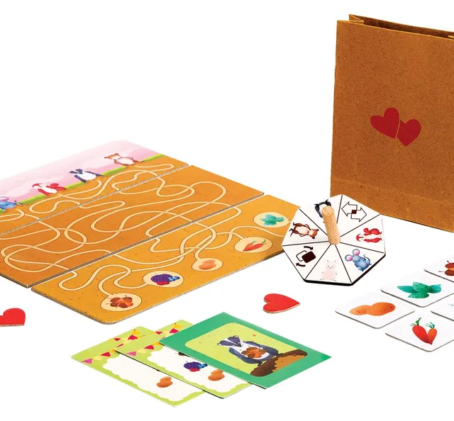 The boards laid out as a maze with the spinner, order cards, food tokens, heart tokens and the paper bag