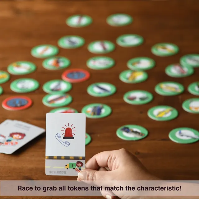 A hand holding a card with a siren above a spread of vehicle tokens: race to grab all the tokens that match