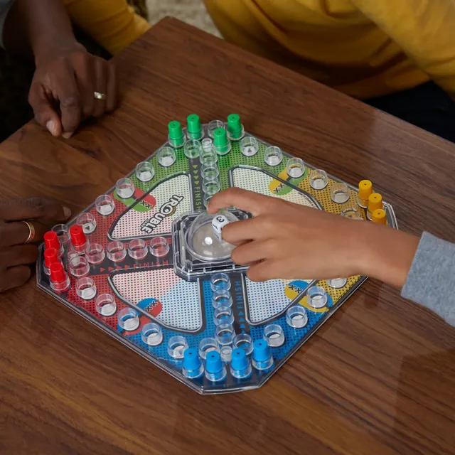 A child pressing the Pop-O-Matic bubble while pegs sit on the board