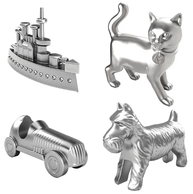 The four tokens: a battleship, a cat, a racing car and a Scottie dog