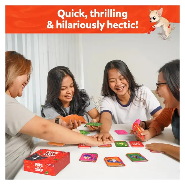 Four friends leaning over a table, slapping cards down on two piles