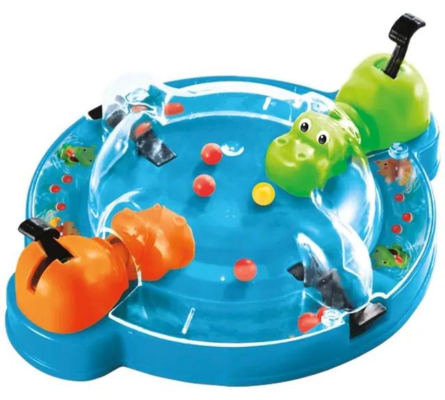The travel unit with an orange and a green hippo and marbles under a clear cover