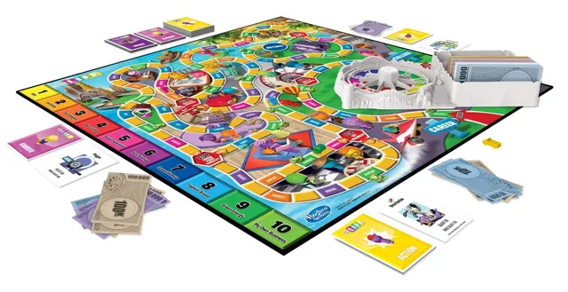 The board with its spinner, cars, pegs, cards and money laid out (English edition shown)