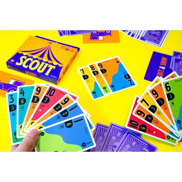 A hand of SCOUT number cards on a yellow table