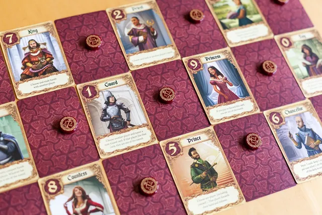Love Letter character cards and red favour tokens spread on a table
