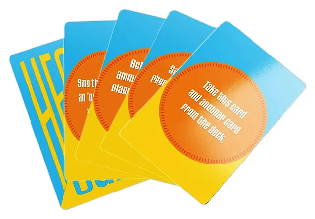 A fan of orange and blue Heads or Tails challenge cards