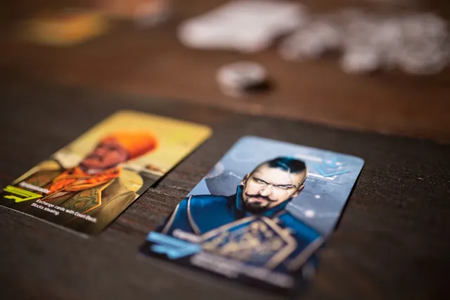 Two character cards face up next to coins