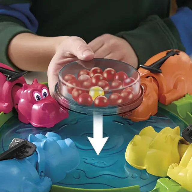 Marbles dropping from the clear storage case into the pond