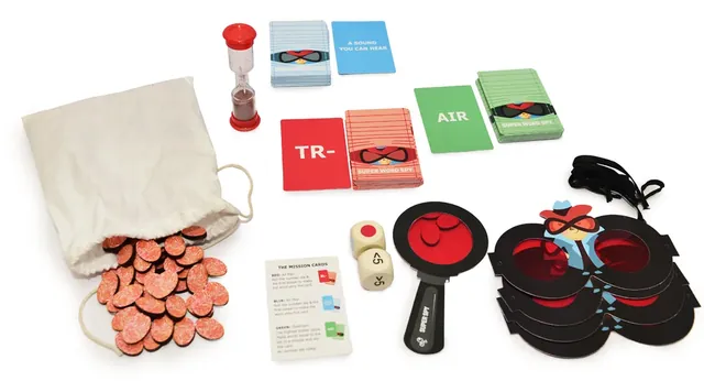 Letter tokens spilling from the cloth bag beside the cards, timer, dice and decoders