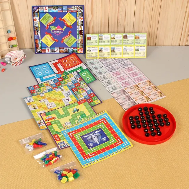 Several Ratna's game boards laid out together, including Business, Ludo and Snakes and Ladders
