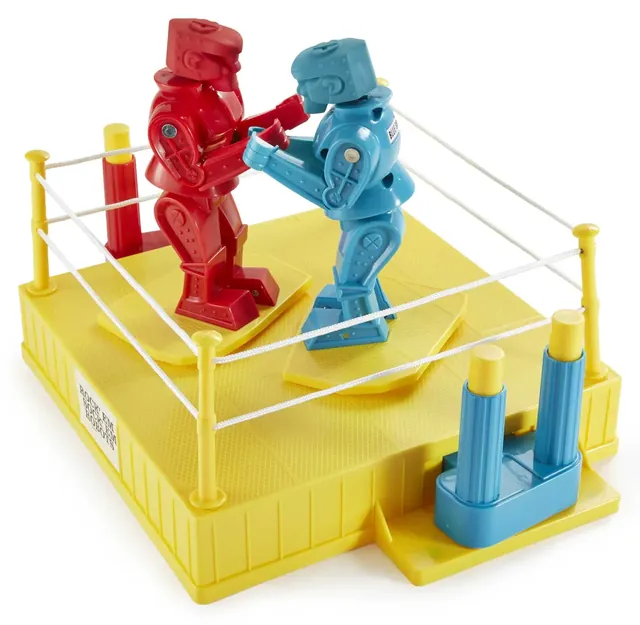 The assembled game: a red and a blue robot squaring up in a yellow ring with white ropes and two controllers