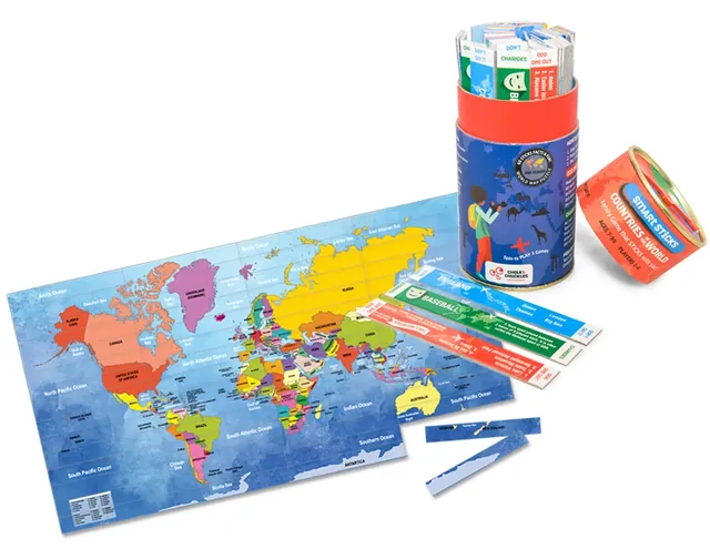 The world map puzzle laid out beside the open tube and spinner