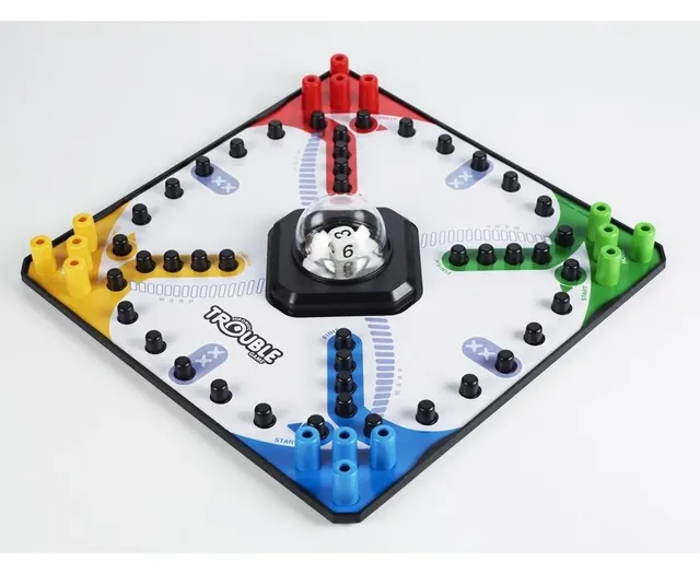 The Trouble board with coloured pegs and the Pop-O-Matic bubble in the centre