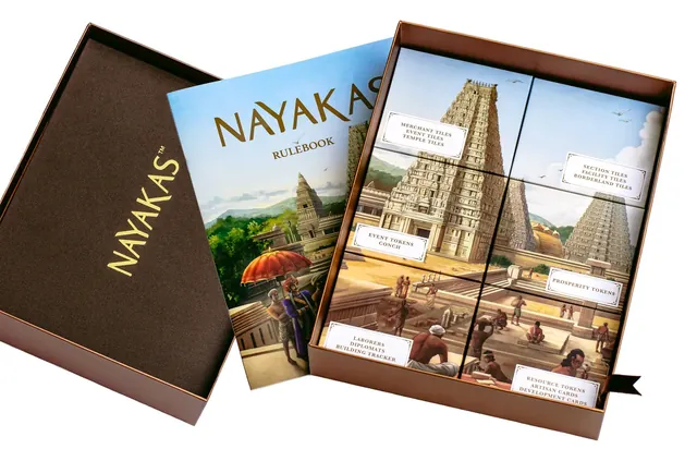 The open box with the Nayakas rulebook and tiles showing temple towers