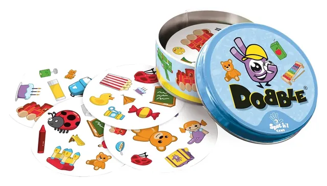 The round Dobble Kids tin beside a spread of round picture cards with toys, a ladybird and a duck