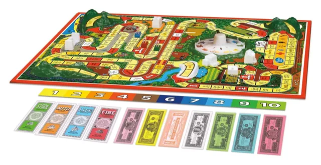 The assembled board from the side, with hills and buildings, and play money in front