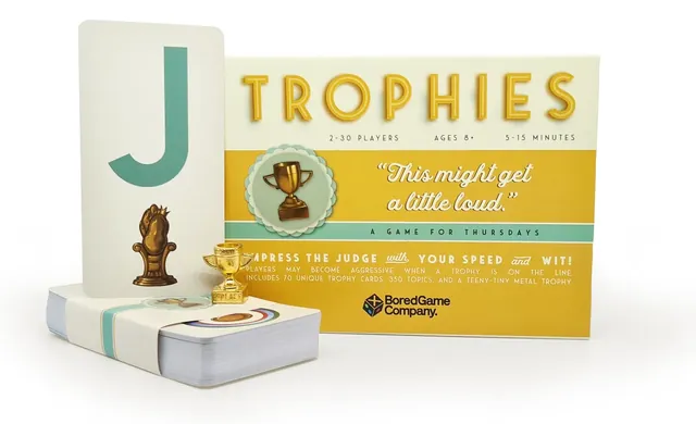The box with the deck, a big letter J card and the tiny metal trophy
