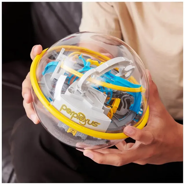 Two hands holding the Perplexus sphere and tilting it