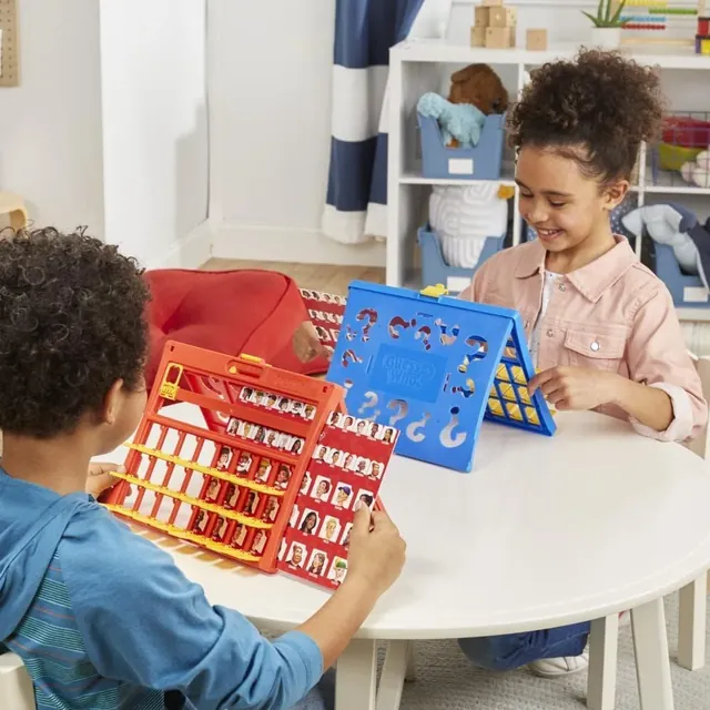 Two children playing the easy-load Guess Who game