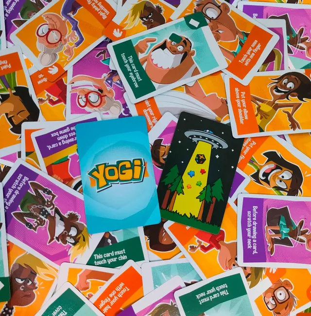 Yogi instruction cards spread out, such as 'This card must touch your chin'