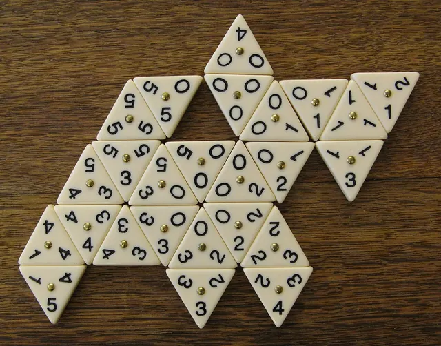 Triangular number tiles joined into a large pattern on a wooden table