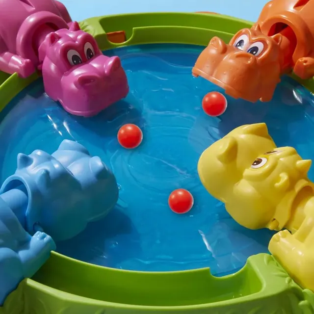 Close-up of the blue pond with red marbles and the hippos' heads