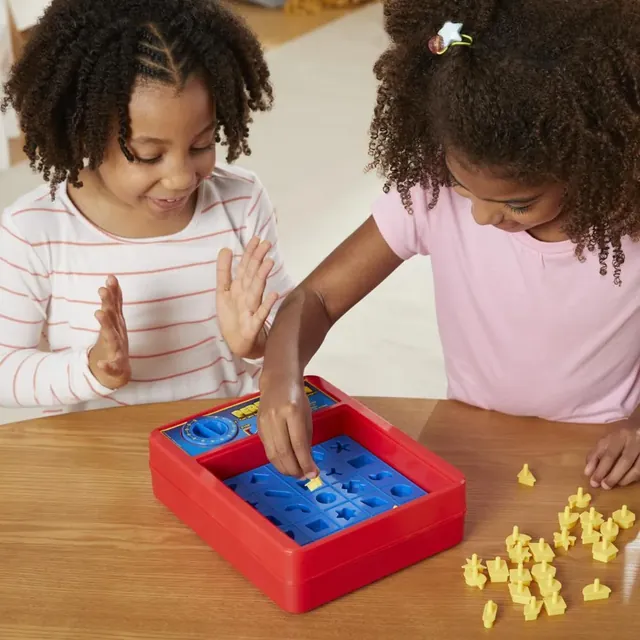 Two girls fitting shapes into the classic Perfection tray