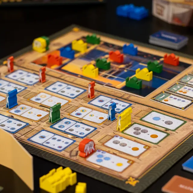 The board in mid-game, covered with coloured Taj markers, workers and an elephant meeple