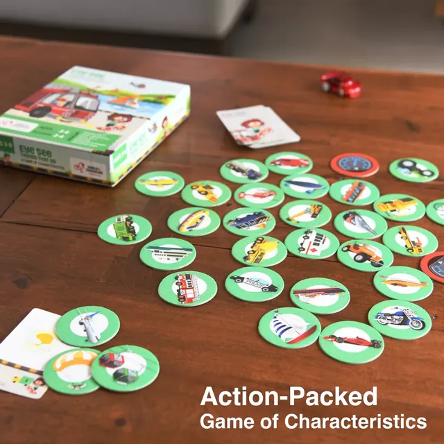 Vehicle tokens spread across a wooden table in front of the box