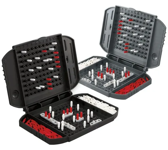 Two open battle cases with ships on the grids and red and white pegs