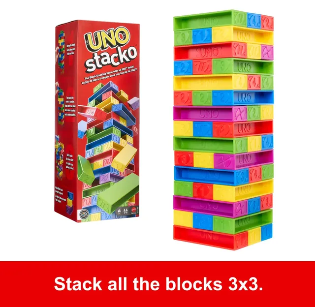 The UNO Stacko box beside a full tower of blocks in red, blue, green, yellow and purple, built three to a layer