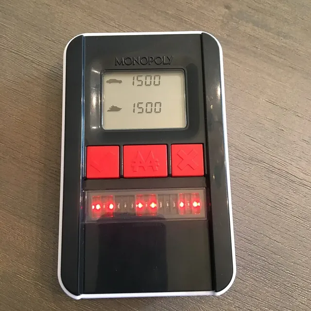 The black Ultimate Banking unit with its screen and red buttons