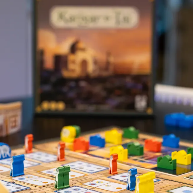 Workers and markers on the board, with the box behind